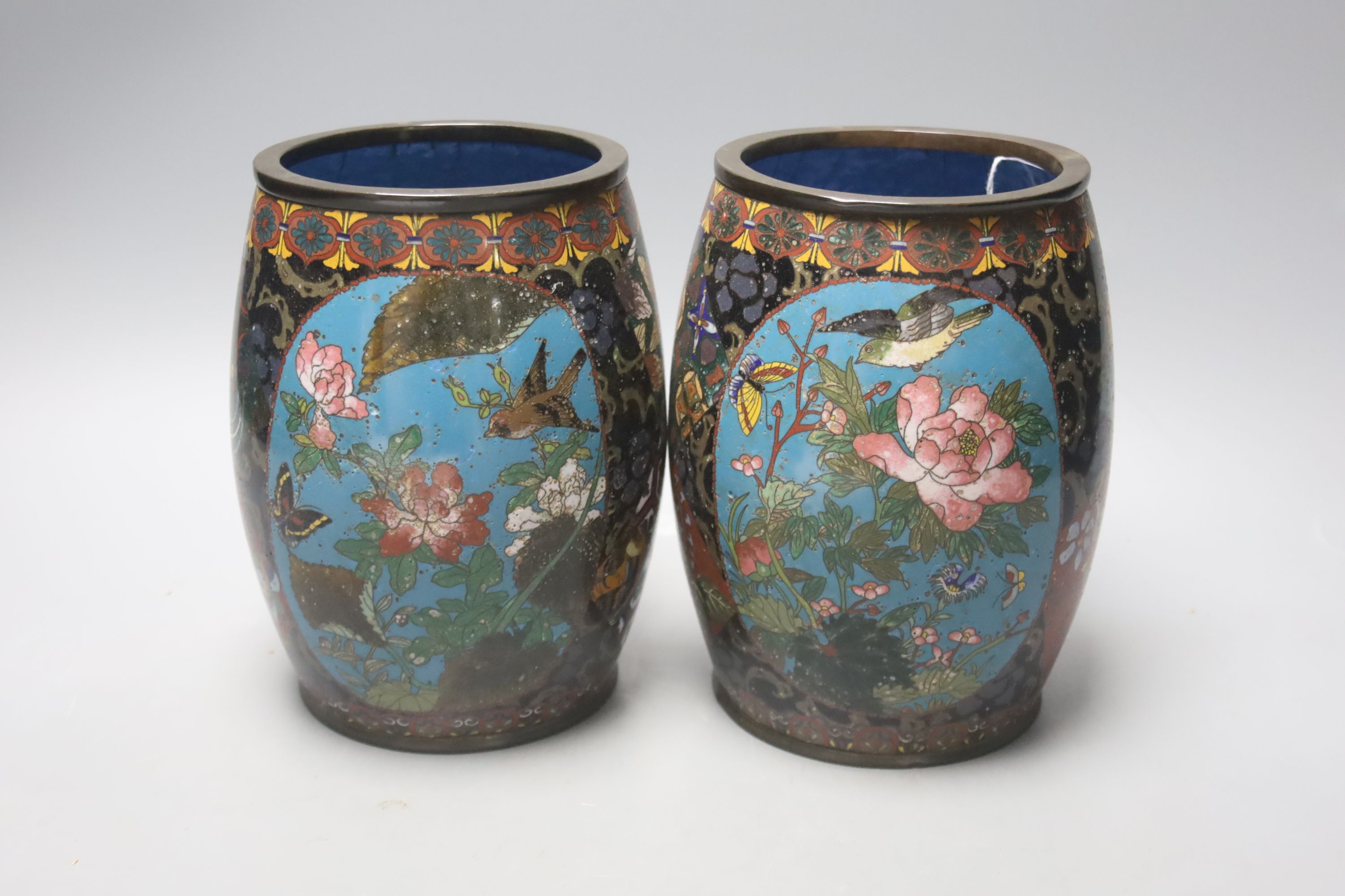 A pair of Japanese cloisonne enamel barrel-shaped vases and a similar bottle vase